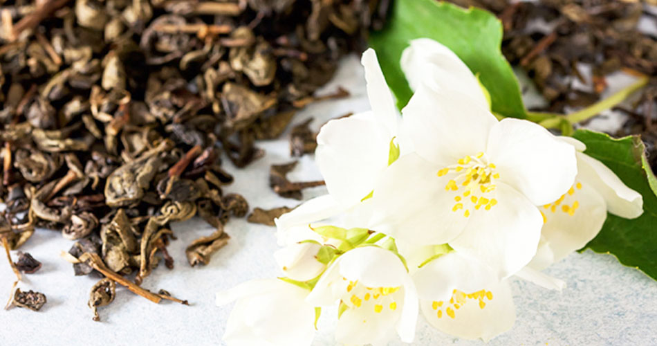 Picture is of a jasmine flower surrounded by tea